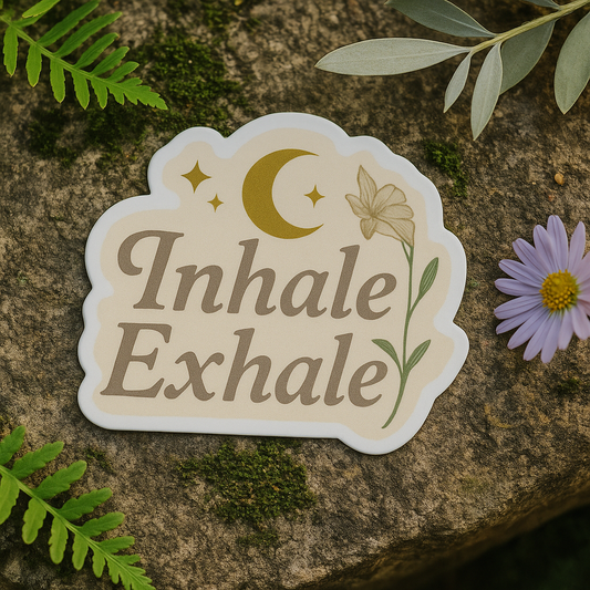 Sticker with 'Inhale Exhale' text on a stone surface with leaves and a flower.