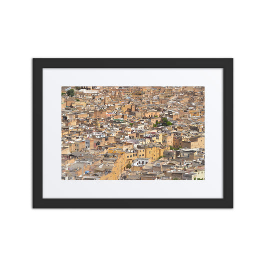 Framed artwork of a cityscape with brown and beige tones.