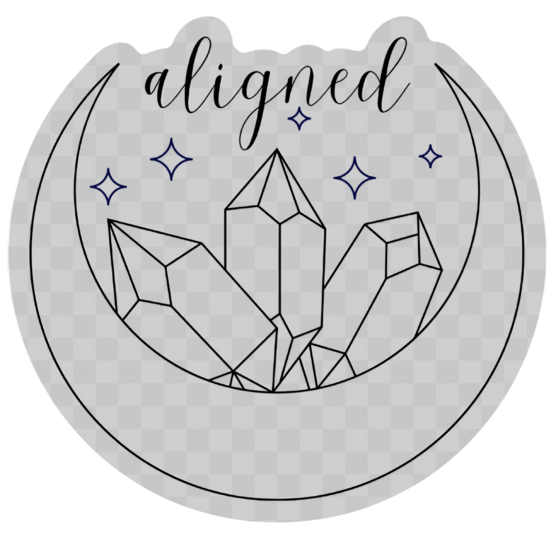 I Am Aligned Crystal sticker placed on a journal, highlighting its durable waterproof vinyl material and enchanting crescent moon motif.
