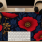 Close-up view of the Vivid Poppy Desk Mat, highlighting the durable hemmed edges and the smooth polyester surface of this anti-slip desk mat for improved mouse tracking.