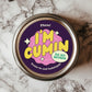 A round sticker with bold typography and vibrant colors, featuring the phrase 'I'm Cumin to My Senses' in yellow and pink on a purple background, designed for use on spice jars or as a quirky gift tag.