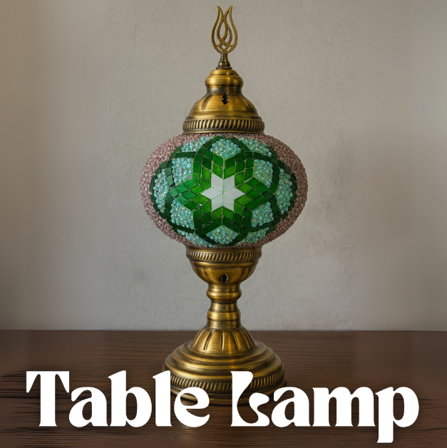 Decorative table lamp with green mosaic design on a wooden surface