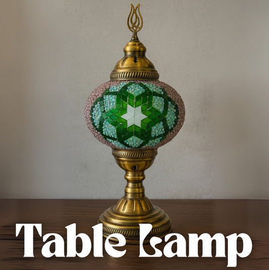 Decorative table lamp with green mosaic design on a wooden surface